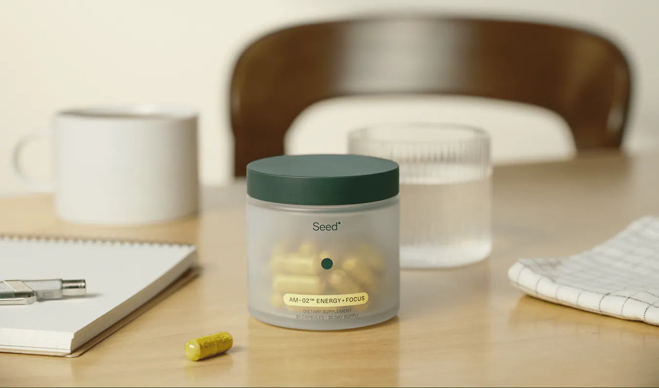 Container of 'Seed' supplements on a desk with a blurred background