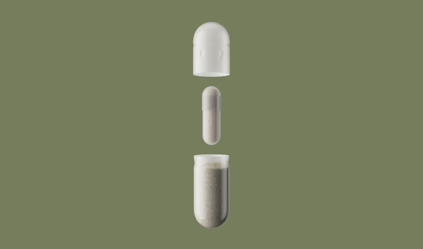Two white capsules on a green background