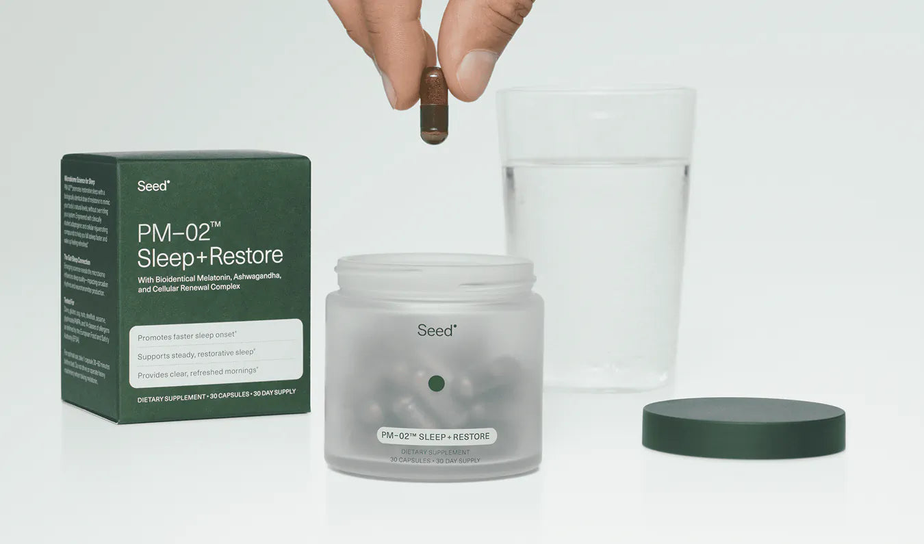 Jar of 'Seed' skincare product with packaging and a glass container on a light gray background
